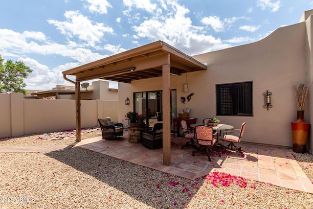 view of patio with an outdoor hangout area and fence