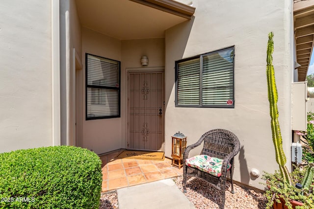 doorway to property with stucco siding