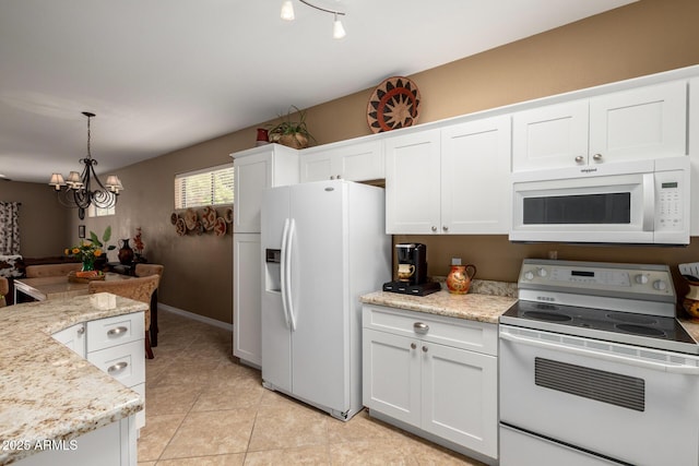 kitchen featuring light tile patterned flooring, white appliances, a notable chandelier, and white cabinets