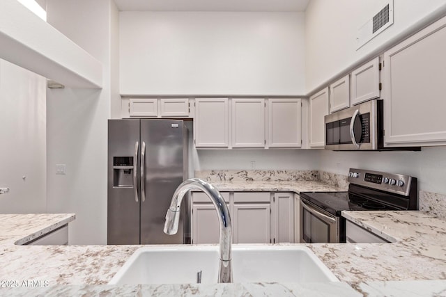 1021 S Greenfield Rd Unit 1211, Mesa, AZ 85206 - kitchen with stainless steel appliances and light stone countertops