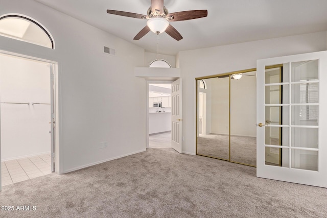 1021 S Greenfield Rd Unit 1211, Mesa, AZ 85206 - unfurnished bedroom featuring carpet flooring, french doors, a closet, ceiling fan, and ensuite bath