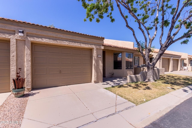 1021 S Greenfield Rd Unit 1211, Mesa, AZ 85206 - view of front facade with driveway, a garage, stucco siding, and a tiled roof