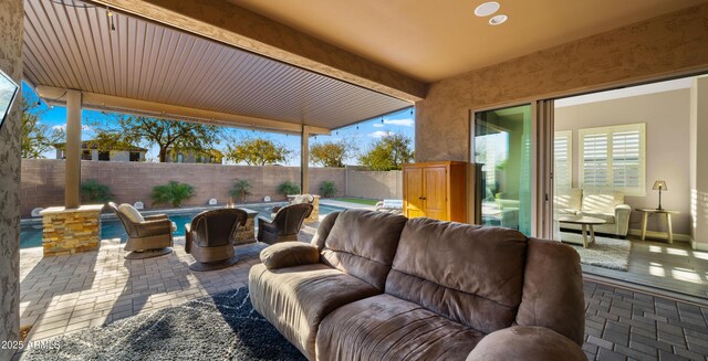 view of patio / terrace featuring an outdoor living space, a fenced backyard, and a fenced in pool