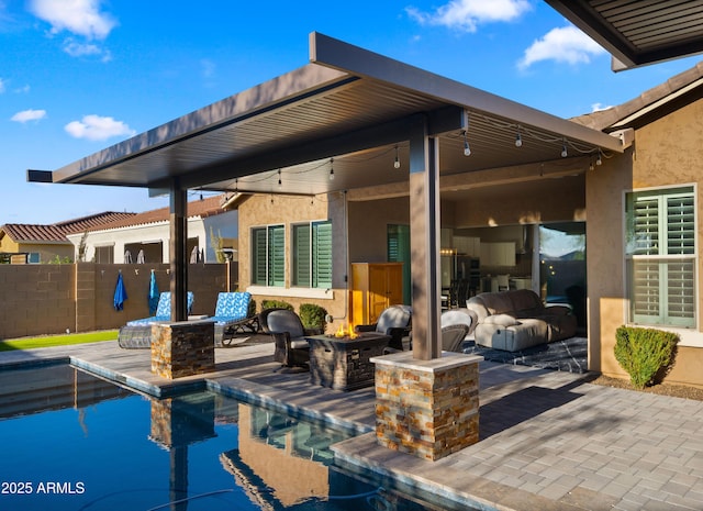 exterior space with a patio area, an outdoor fire pit, fence, and a fenced in pool