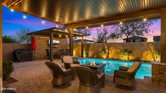 view of patio featuring a fenced in pool, an outdoor fire pit, and a fenced backyard