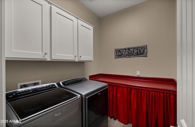 laundry room with cabinet space and washing machine and clothes dryer