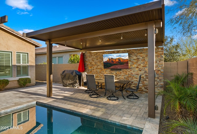 view of pool with a patio, fence, a gazebo, a fenced in pool, and outdoor dining space