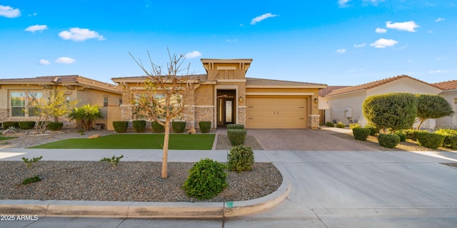 view of front facade with stone siding, driveway, an attached garage, and stucco siding