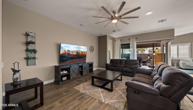 living room featuring a ceiling fan, visible vents, baseboards, and wood finished floors