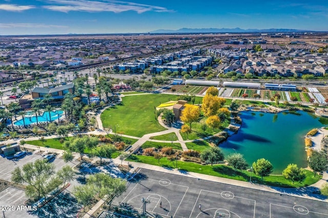 drone / aerial view featuring a water and mountain view