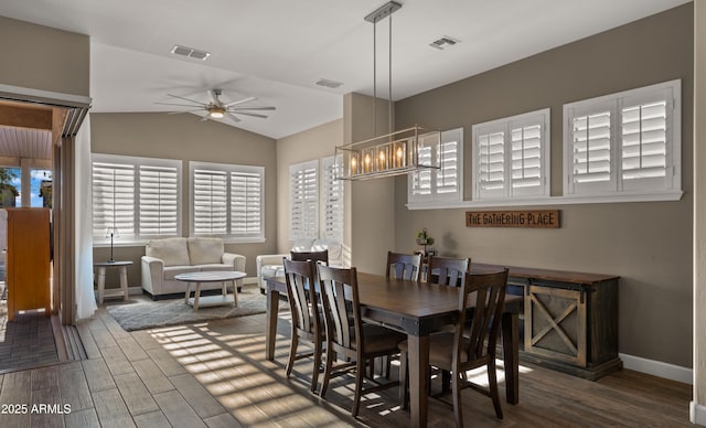 dining area with visible vents, vaulted ceiling, and wood finished floors