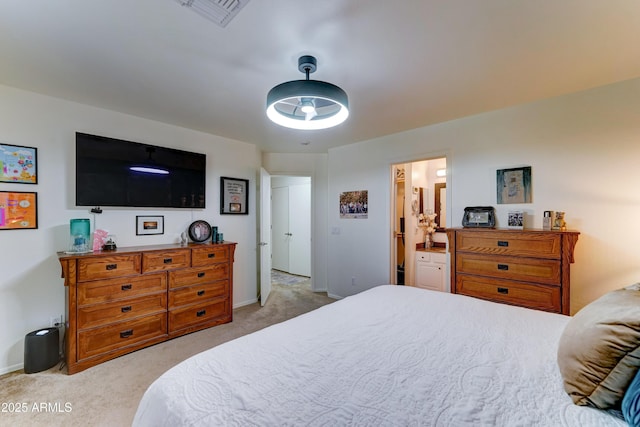 2101 S Meridian Rd Unit 250, Apache Junction, AZ 85120 - bedroom with light carpet, baseboards, and ensuite bathroom