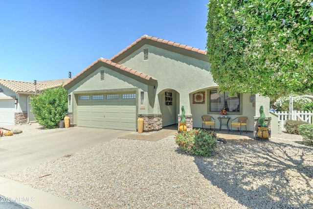 2101 S Meridian Rd Unit 250, Apache Junction, AZ 85120 - mediterranean / spanish-style home featuring stucco siding, a garage, driveway, a tile roof, and fence