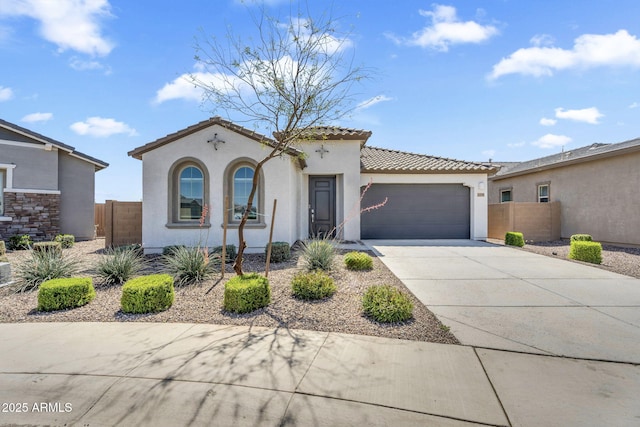 3339 E Malibu Dr, San Tan Valley, AZ 85143 - mediterranean / spanish-style house with a tiled roof, an attached garage, fence, concrete driveway, and stucco siding