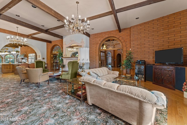 living room featuring coffered ceiling, hardwood / wood-style flooring, brick wall, beamed ceiling, and an inviting chandelier