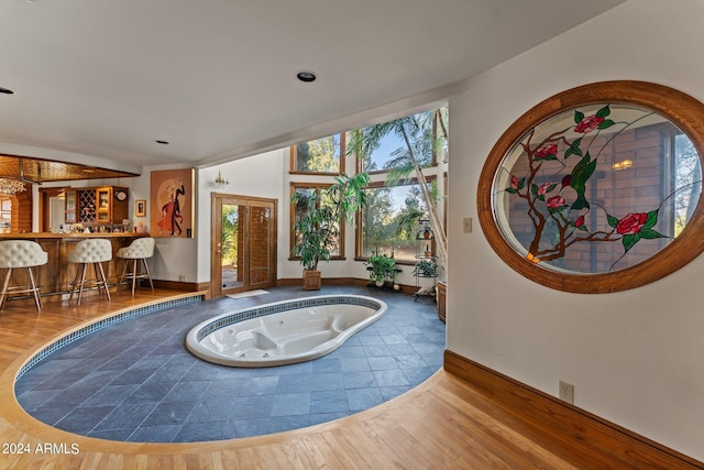 foyer with hardwood / wood-style floors and bar area