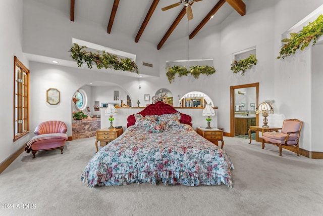 carpeted bedroom with high vaulted ceiling, ceiling fan, and beamed ceiling