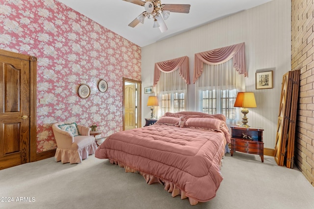 bedroom with brick wall, light colored carpet, and ceiling fan