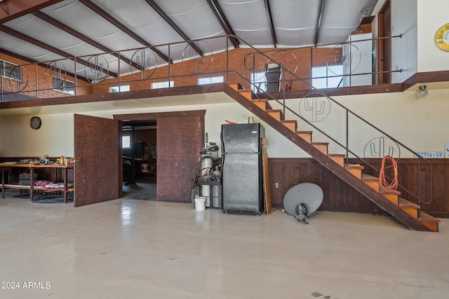 interior space with a towering ceiling and concrete floors