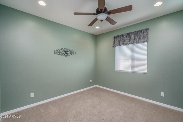 spare room with ceiling fan and carpet floors