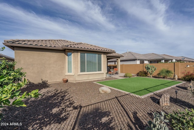 rear view of property with a patio area and a yard