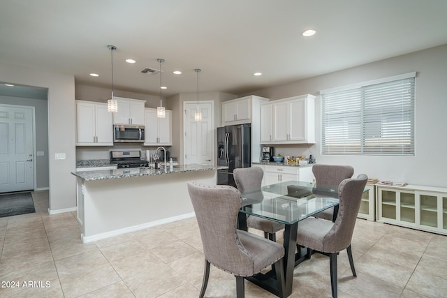 tiled dining room featuring sink