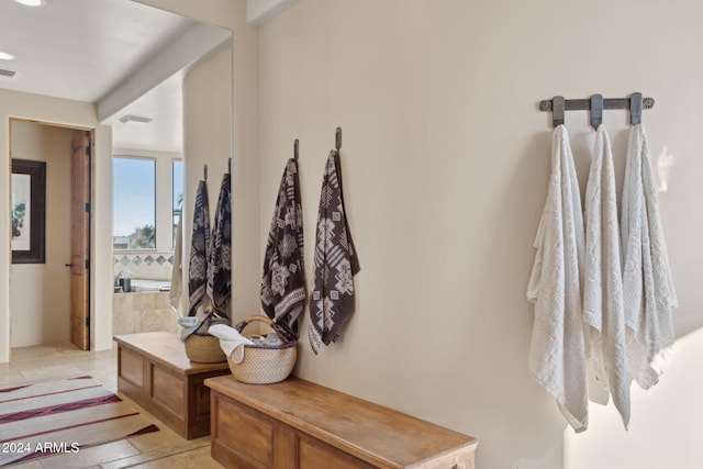 bathroom with tile patterned floors and a bathtub