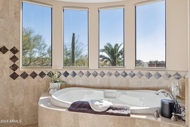 bathroom with a wealth of natural light and tile walls