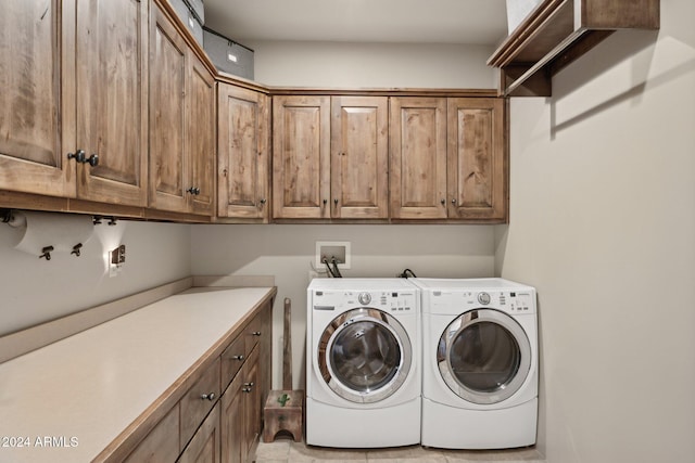 laundry room with cabinets and washing machine and clothes dryer