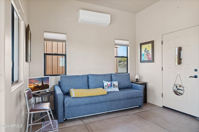 living room with concrete flooring and a wall mounted AC