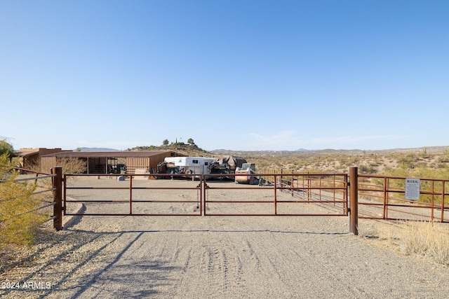 view of gate with a rural view