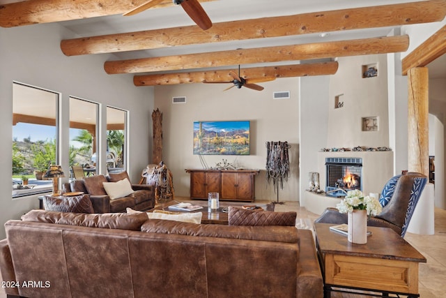 living room with beamed ceiling, light tile patterned floors, and ceiling fan