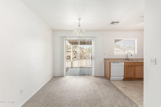 unfurnished dining area featuring light carpet, sink, and a chandelier