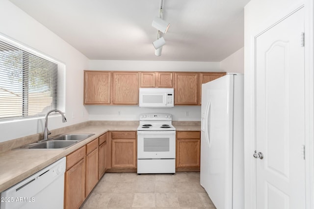 kitchen featuring white appliances, track lighting, and sink