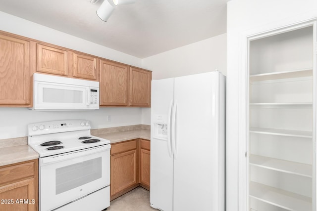 kitchen featuring white appliances and light tile patterned floors