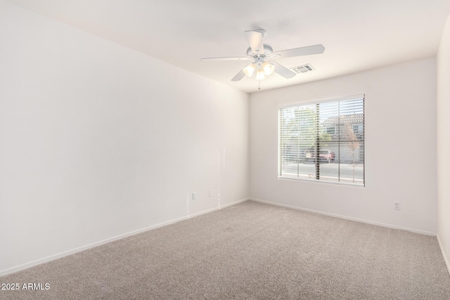 carpeted spare room with ceiling fan