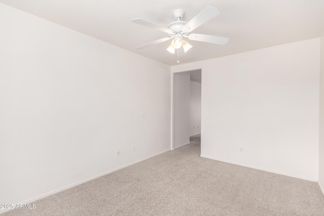 carpeted spare room with ceiling fan