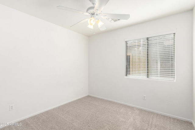 empty room with ceiling fan and carpet