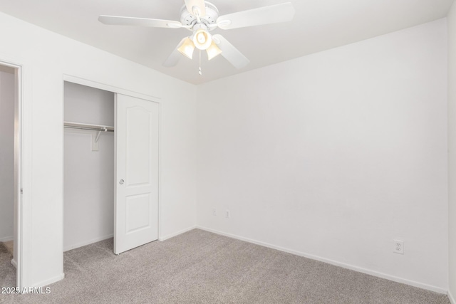 unfurnished bedroom featuring light colored carpet, a closet, and ceiling fan