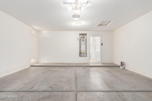 garage with water heater and a garage door opener