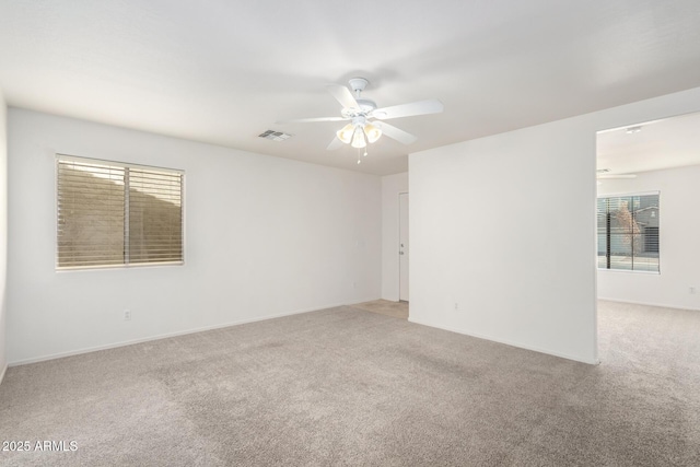 spare room with carpet and ceiling fan