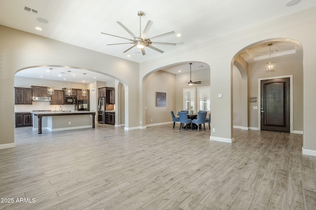 22255 E Quintero Rd, Queen Creek, AZ 85142 - unfurnished living room with ceiling fan, light wood-type flooring, a sink, recessed lighting, and baseboards
