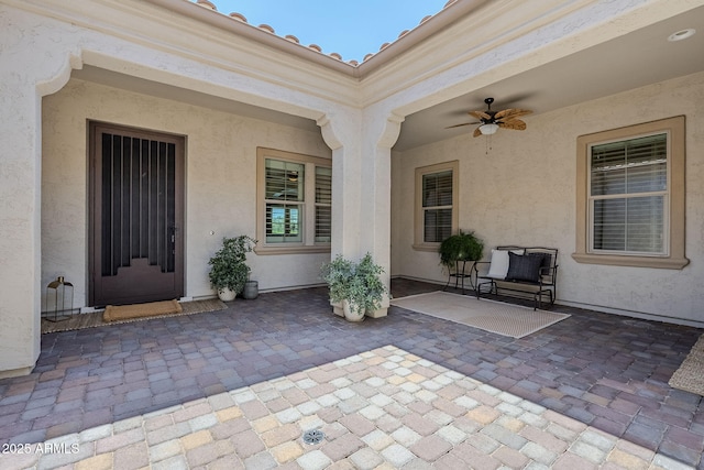22255 E Quintero Rd, Queen Creek, AZ 85142 - view of exterior entry featuring ceiling fan, a patio, and stucco siding
