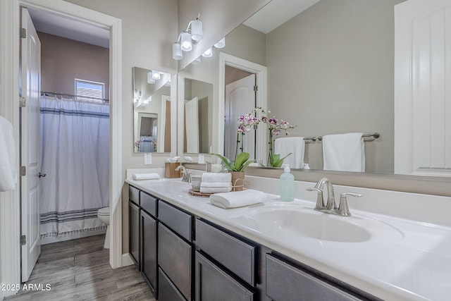 22255 E Quintero Rd, Queen Creek, AZ 85142 - full bathroom with toilet, double vanity, wood finished floors, and a shower with curtain