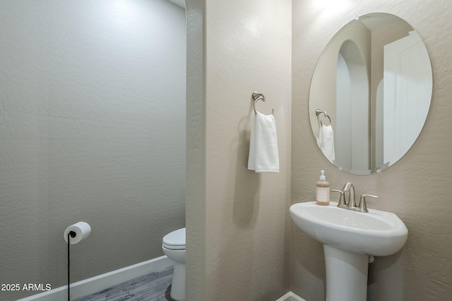 22255 E Quintero Rd, Queen Creek, AZ 85142 - bathroom with toilet, wood finished floors, and baseboards