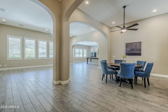 22255 E Quintero Rd, Queen Creek, AZ 85142 - dining room with ceiling fan, arched walkways, wood finished floors, baseboards, and recessed lighting