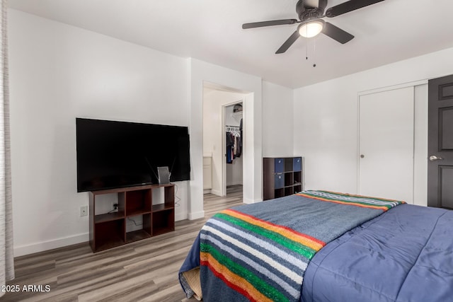 bedroom featuring ceiling fan, hardwood / wood-style floors, and a closet