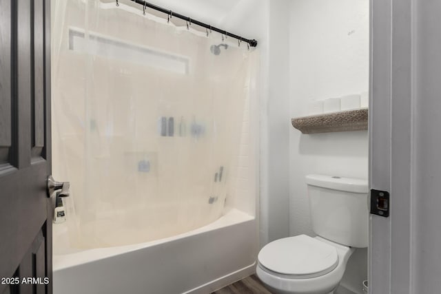 bathroom with hardwood / wood-style flooring, bathing tub / shower combination, and toilet