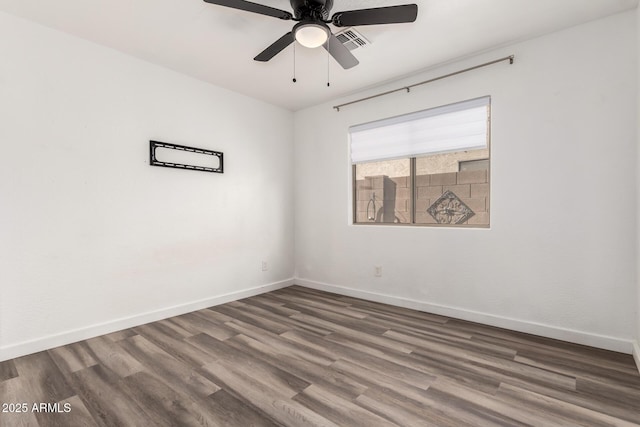 spare room with hardwood / wood-style flooring and ceiling fan