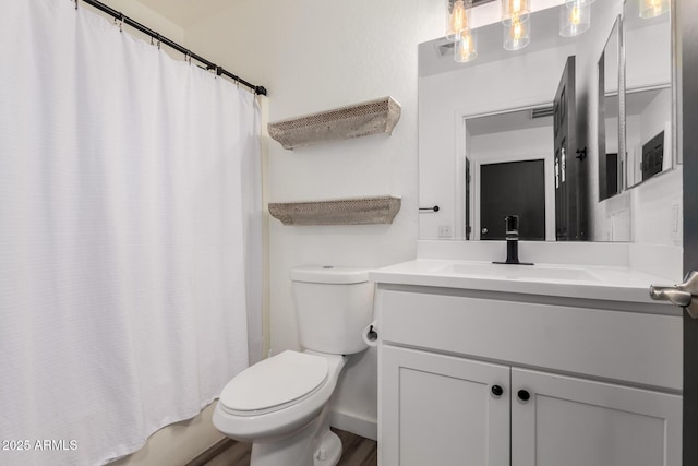 full bathroom with vanity, shower / bath combo, and toilet